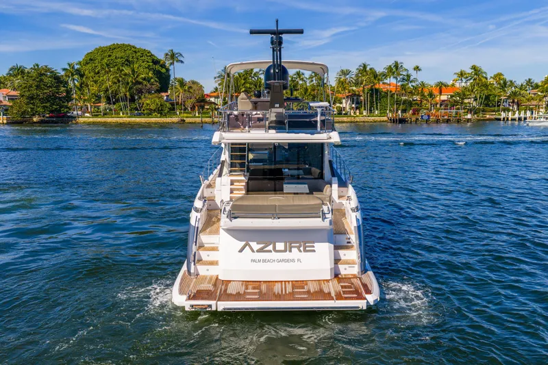 Azure Yacht Photos Pics 2021 Azimut S6 yacht cruising on a sunny day near lush waterfront homes.