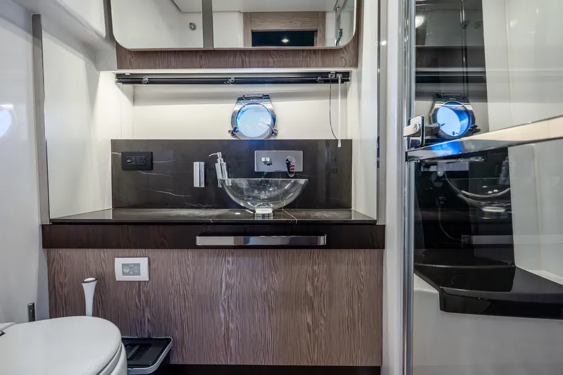 Azure Yacht Photos Pics Luxurious bathroom interior of 2021 Azimut S6 yacht with modern fixtures and porthole window.