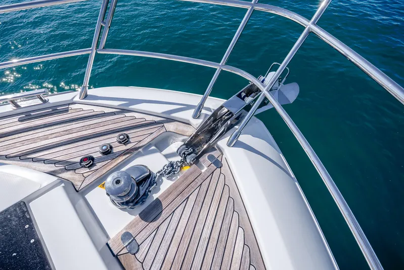 Azure Yacht Photos Pics Bow of 2021 Azimut S6 yacht with anchor and teak decking on blue water.