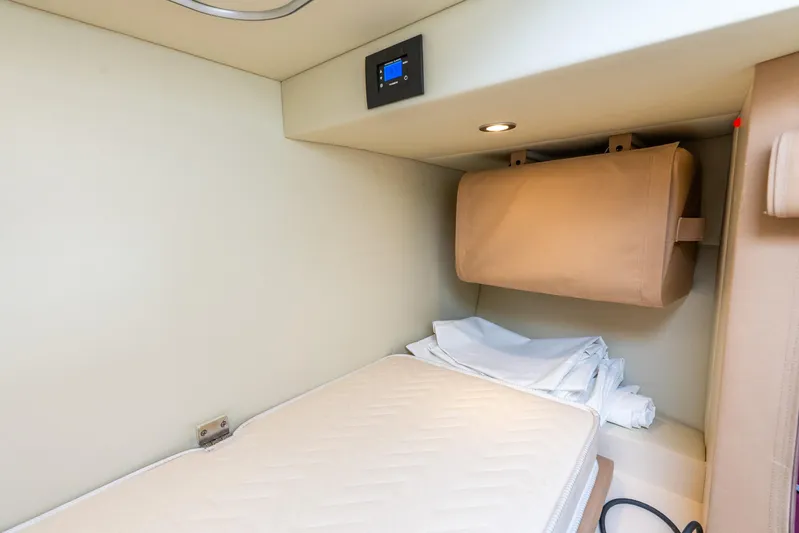 Azure Yacht Photos Pics 2021 Azimut S6 yacht interior cabin with bed and storage compartment.