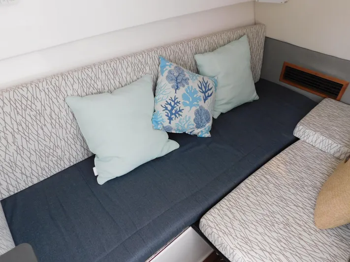 Out To Lunch Yacht Photos Pics Interior seating area of a 2019 Everglades 340 DC boat with decorative pillows.