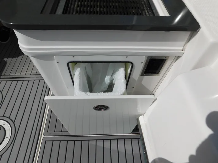 Out To Lunch Yacht Photos Pics Trash bin compartment on 2019 Everglades 340 DC boat with sleek design.