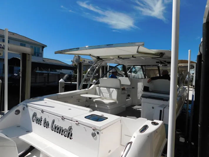 Out To Lunch Yacht Photos Pics 2019 Everglades 340 DC boat docked, named Out to Lunch, with open seating area.