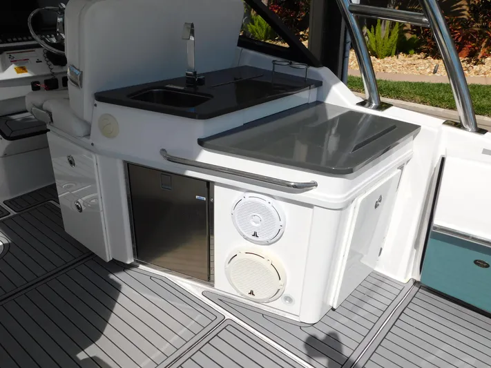 Out To Lunch Yacht Photos Pics 2019 Everglades 340 DC boat interior with sink, storage, and speakers.