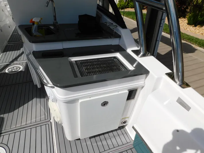 Out To Lunch Yacht Photos Pics 2019 Everglades 340 DC boat interior with sink and grill station.