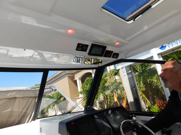 Out To Lunch Yacht Photos Pics Interior view of 2019 Everglades 340 DC boat cockpit with dashboard and controls.