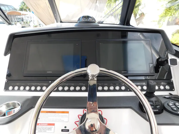 Out To Lunch Yacht Photos Pics Dashboard of a 2019 Everglades 340 DC boat with dual Garmin displays.