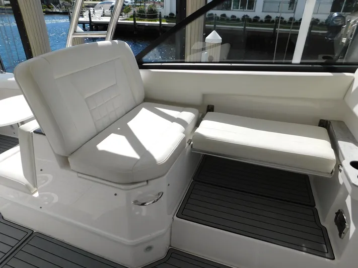 Out To Lunch Yacht Photos Pics 2019 Everglades 340 DC boat interior seating area with white cushioned seats.