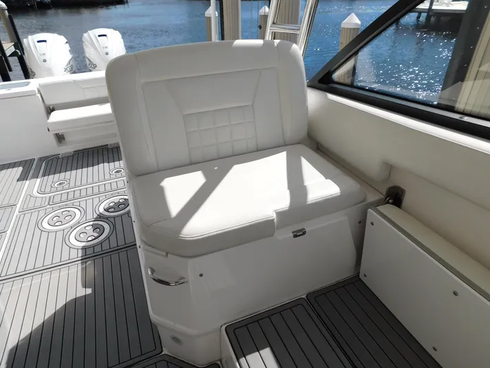 Out To Lunch Yacht Photos Pics 2019 Everglades 340 DC boat interior with white seating and deck by the water.