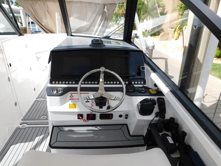 Out To Lunch Yacht Photos Pics 2019 Everglades 340 DC boat helm with steering wheel and control panel.