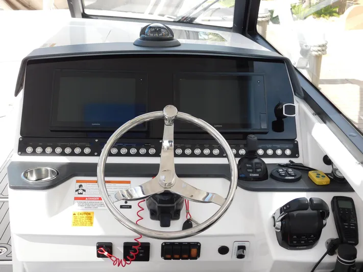 Out To Lunch Yacht Photos Pics 2019 Everglades 340 DC boat helm with dual displays and navigation controls.