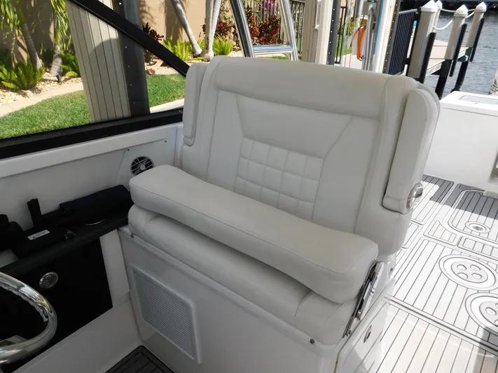 Out To Lunch Yacht Photos Pics 2019 Everglades 340 DC boat with white cushioned captain's chair and modern interior.