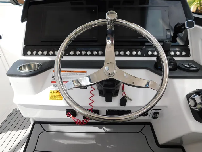 Out To Lunch Yacht Photos Pics 2019 Everglades 340 DC helm with stainless steel steering wheel and control panel.