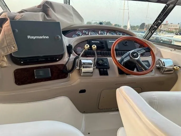  Yacht Photos Pics 2001 Sea Ray 380 Sundancer helm with Raymarine navigation, wooden steering wheel, and control panel.