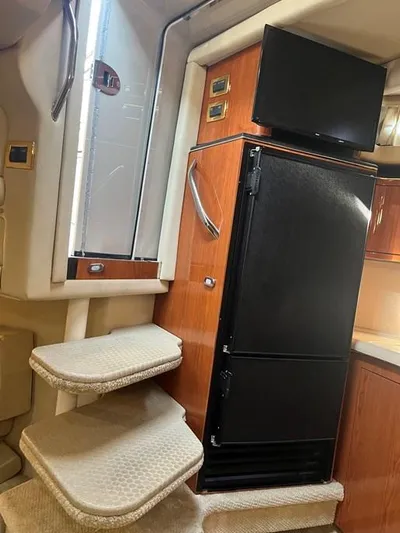  Yacht Photos Pics Interior of 2001 Sea Ray 380 Sundancer with stairs, fridge, and TV.