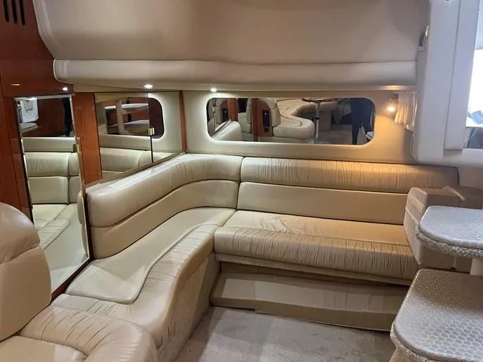  Yacht Photos Pics Luxurious interior of 2001 Sea Ray 380 Sundancer with beige leather seating and elegant lighting.