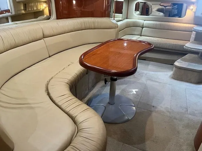  Yacht Photos Pics Luxurious interior of 2001 Sea Ray 380 Sundancer yacht with plush seating and wooden table.