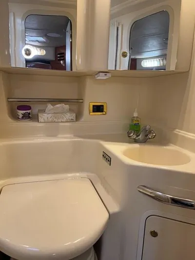  Yacht Photos Pics 2001 Sea Ray 380 Sundancer bathroom with sink, mirror, and storage cabinets.