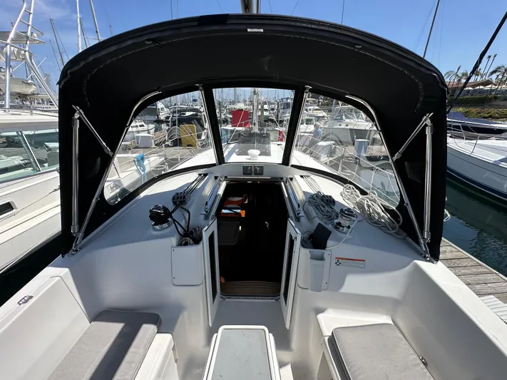 Wind Hunter Yacht Photos Pics 2013 Hunter 33 sailboat cockpit with black canopy, docked in marina.
