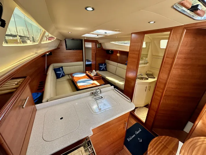 Wind Hunter Yacht Photos Pics Luxurious interior of 2013 Hunter 33 sailboat with modern amenities and elegant wood finish.