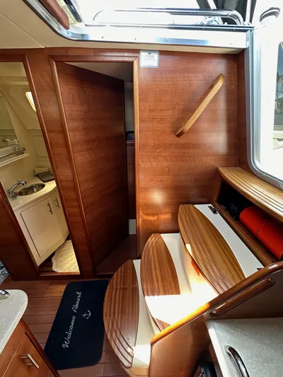 Wind Hunter Yacht Photos Pics Interior of 2013 Hunter 33 sailboat with wooden finishes and compact bathroom.
