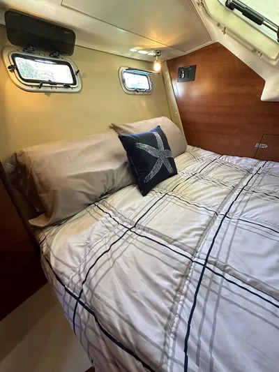 Wind Hunter Yacht Photos Pics Cozy cabin interior of 2013 Hunter 33 sailboat with nautical-themed bedding.