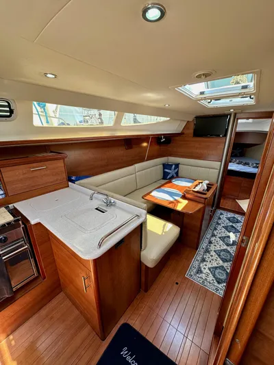 Wind Hunter Yacht Photos Pics 2013 Hunter 33 yacht interior with modern kitchen, dining area, and cozy seating.