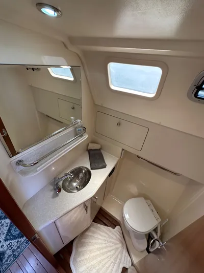 Wind Hunter Yacht Photos Pics 2013 Hunter 33 yacht bathroom with sink, mirror, and toilet.