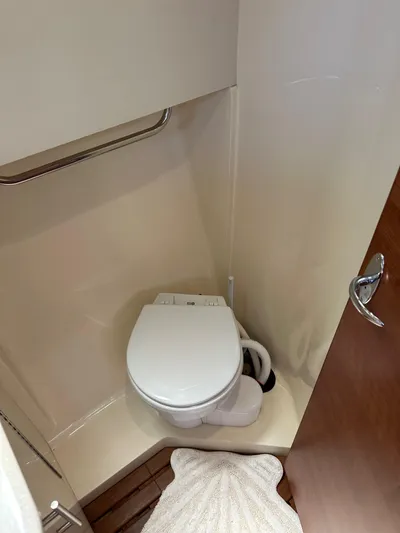 Wind Hunter Yacht Photos Pics 2013 Hunter 33 yacht bathroom with compact toilet and wooden flooring.