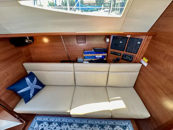 Wind Hunter Yacht Photos Pics Interior of 2013 Hunter 33 yacht with beige sofa and nautical-themed decor.