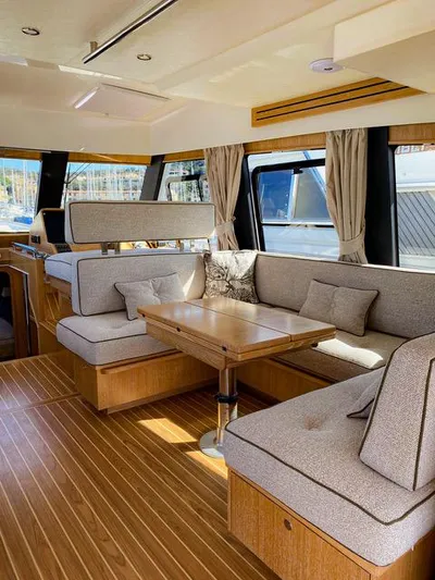  Yacht Photos Pics Luxurious interior of 2019 Sasga Yachts Menorquin 54 with elegant seating and wooden flooring.