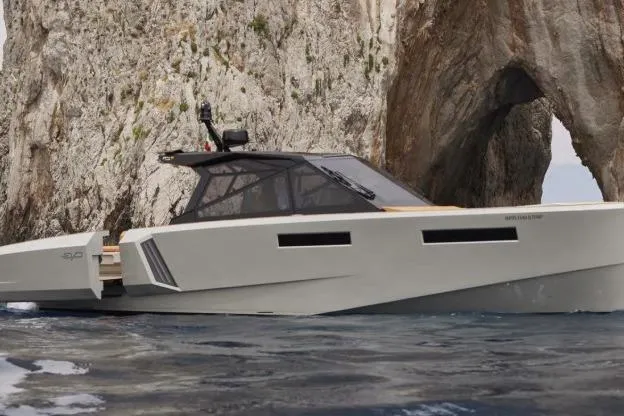  Yacht Photos Pics 2024 Evo Yachts R4+ cruising near rocky coastal arch formation.