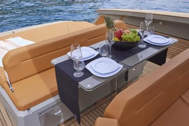  Yacht Photos Pics Luxurious 2024 Evo Yachts R4+ dining setup with elegant tableware and fruit arrangement.