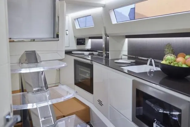  Yacht Photos Pics Modern kitchen interior of 2024 Evo Yachts R4+ with sleek design and appliances.