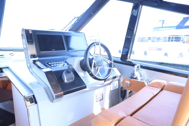  Yacht Photos Pics 2024 Evo Yachts R4+ helm with modern controls and luxurious seating.