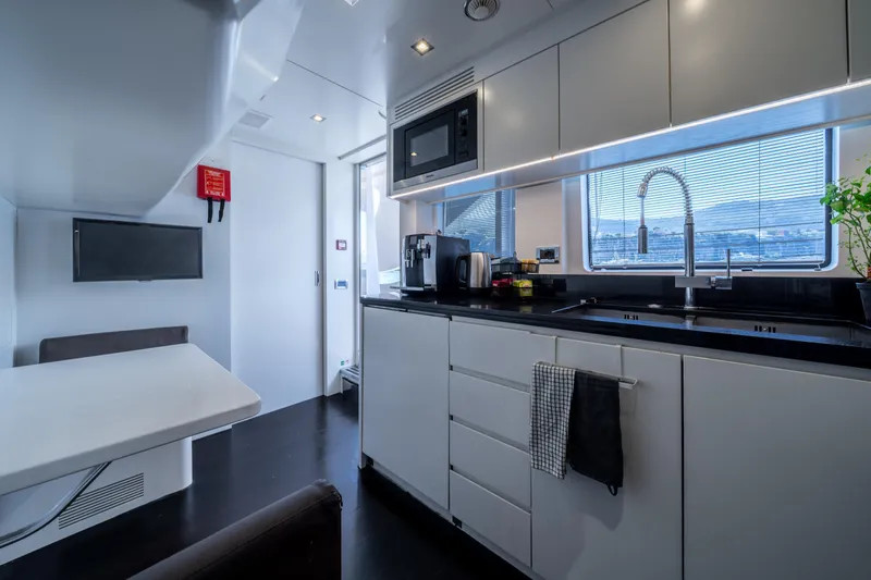 Horizon Yacht Photos Pics Modern kitchen interior on a 2016 Benetti 93' yacht, featuring sleek cabinetry and appliances.