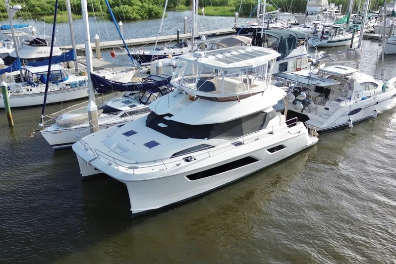 Tonga Time Yacht Photos Pics Aquila 44 yacht, 2019 model, docked at a marina with other boats.