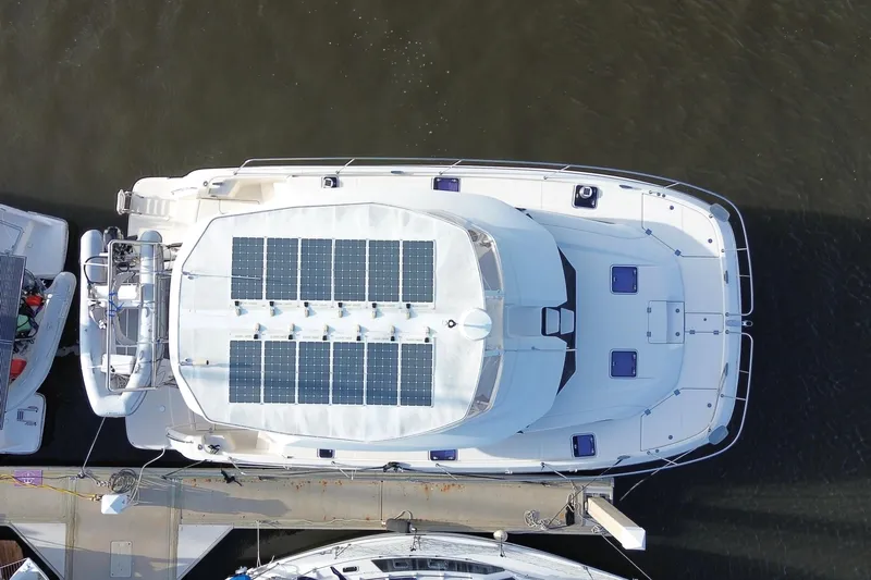 Tonga Time Yacht Photos Pics Aerial view of 2019 Aquila 44 yacht with solar panels docked at marina.