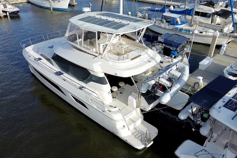 Tonga Time Yacht Photos Pics Aquila 44 yacht, 2019 model, docked at marina with solar panels on roof.