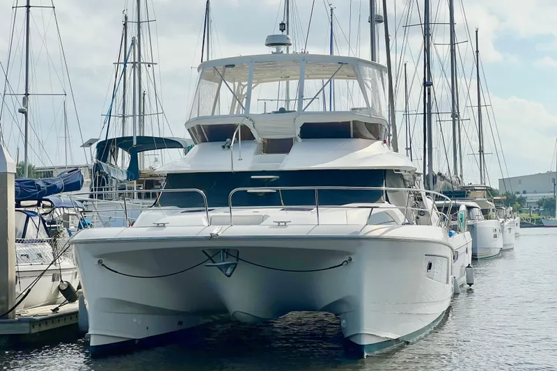Tonga Time Yacht Photos Pics 2019 Aquila 44 yacht docked at marina, surrounded by sailboats.