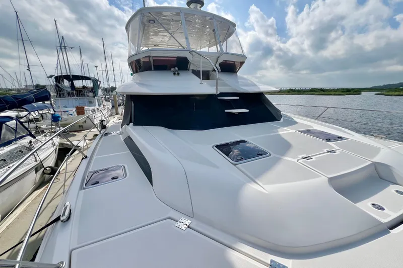 Tonga Time Yacht Photos Pics Aquila 44 yacht, 2019 model, docked with clear sky and water view.