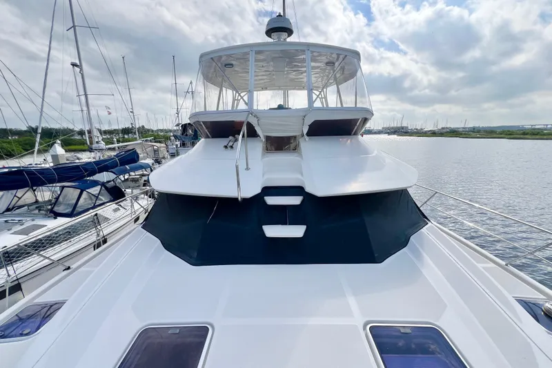 Tonga Time Yacht Photos Pics 2019 Aquila 44 yacht docked at marina under cloudy sky.