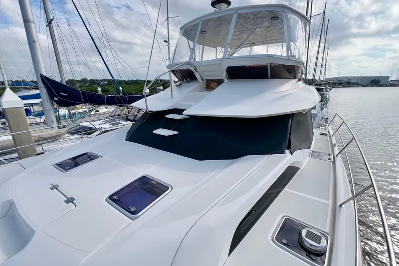 Tonga Time Yacht Photos Pics 2019 Aquila 44 yacht docked at marina, showcasing sleek design and spacious deck.