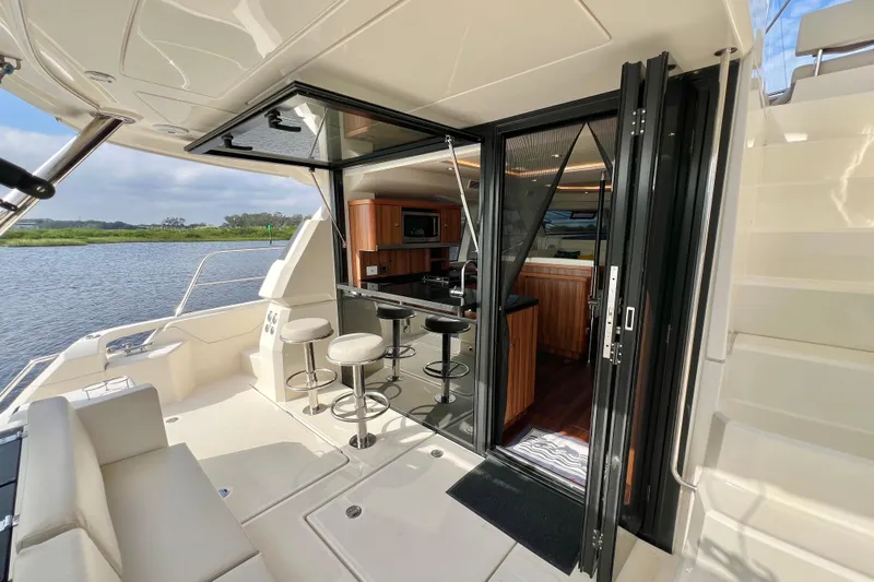 Tonga Time Yacht Photos Pics Luxurious 2019 Aquila 44 yacht interior with modern kitchen and seating area by the water.