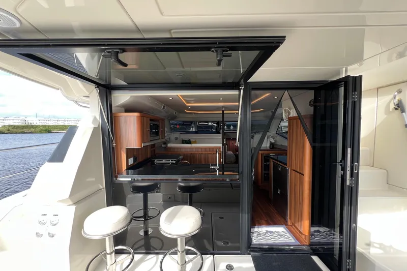 Tonga Time Yacht Photos Pics Luxurious 2019 Aquila 44 yacht interior with modern kitchen and bar stools.