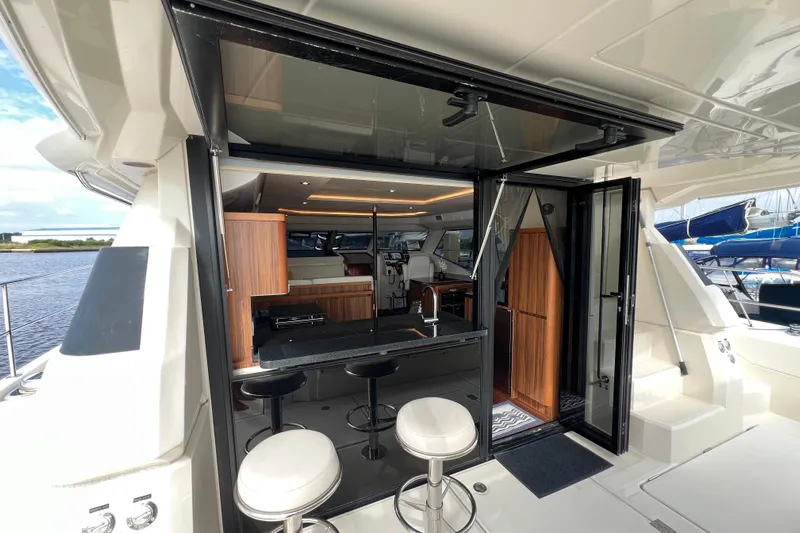 Tonga Time Yacht Photos Pics Luxurious 2019 Aquila 44 yacht interior with modern kitchen and bar stools.