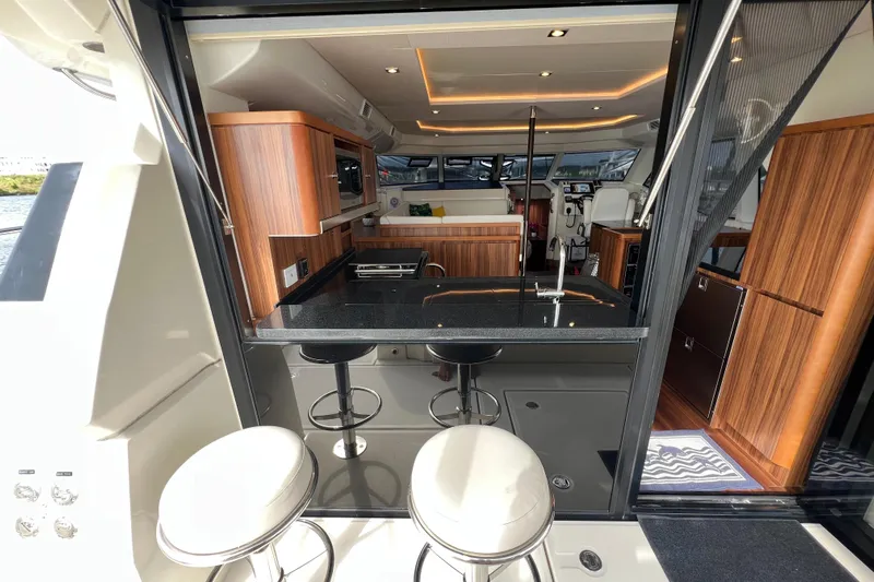 Tonga Time Yacht Photos Pics Luxurious 2019 Aquila 44 yacht interior with modern kitchen and seating area.