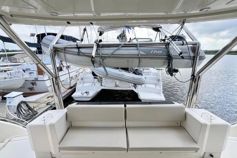 Tonga Time Yacht Photos Pics Aquila 44 yacht interior with docked boats and inflatable dinghy, 2019 model.