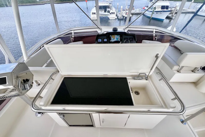 Tonga Time Yacht Photos Pics Flybridge of 2019 Aquila 44 yacht with open sink and marina view.