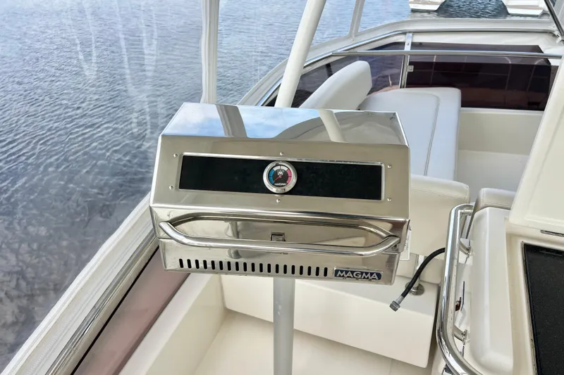 Tonga Time Yacht Photos Pics Stainless steel grill on 2019 Aquila 44 yacht, overlooking water.